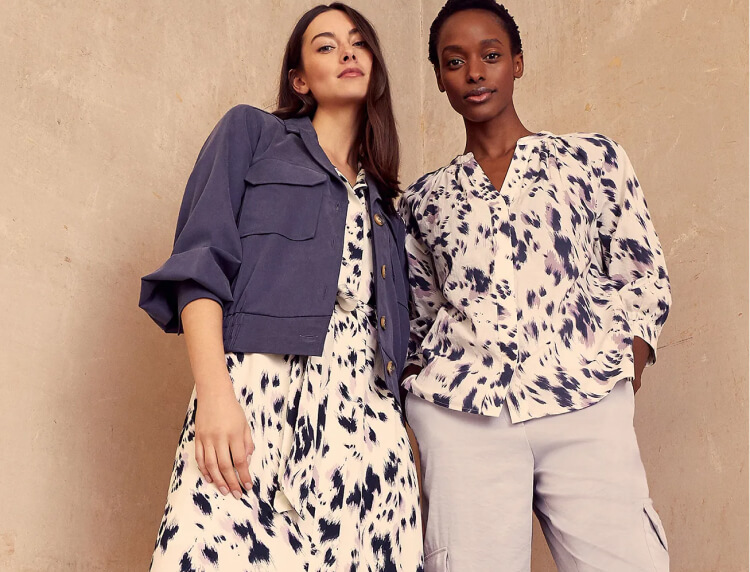 Woman wearing dress and jacket, woman wearing printed shirt and trousers