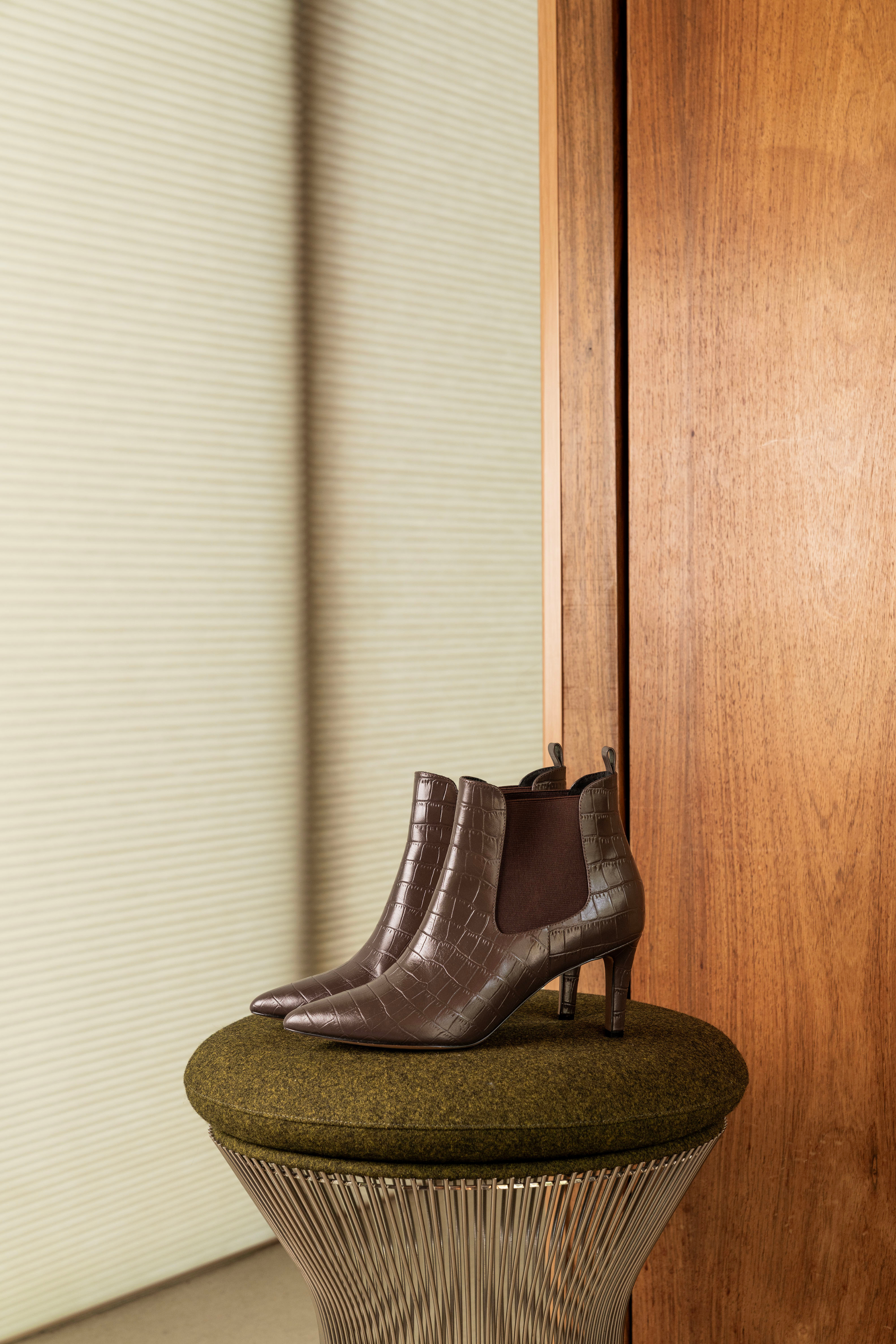Brown croc-effect heeled ankle boots.