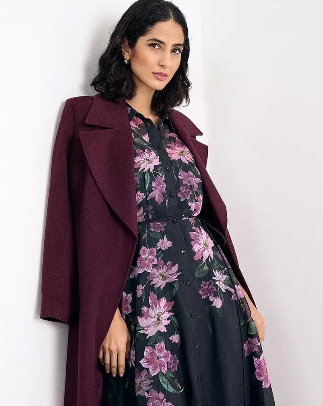 A woman wearing a Hobbs floral midi shirt dress.