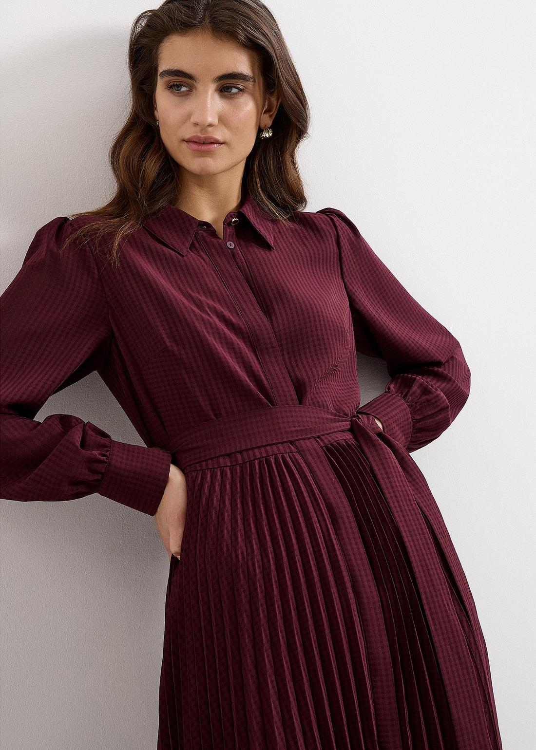 A woman wearing the Ren dress, side view.