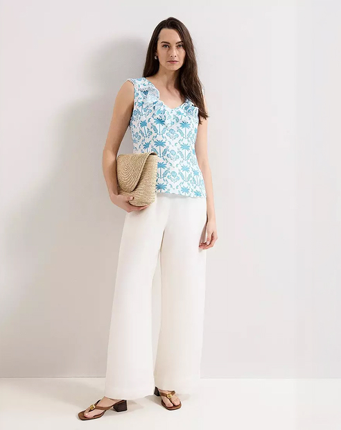 Woman in Phase Eight white linen trousers