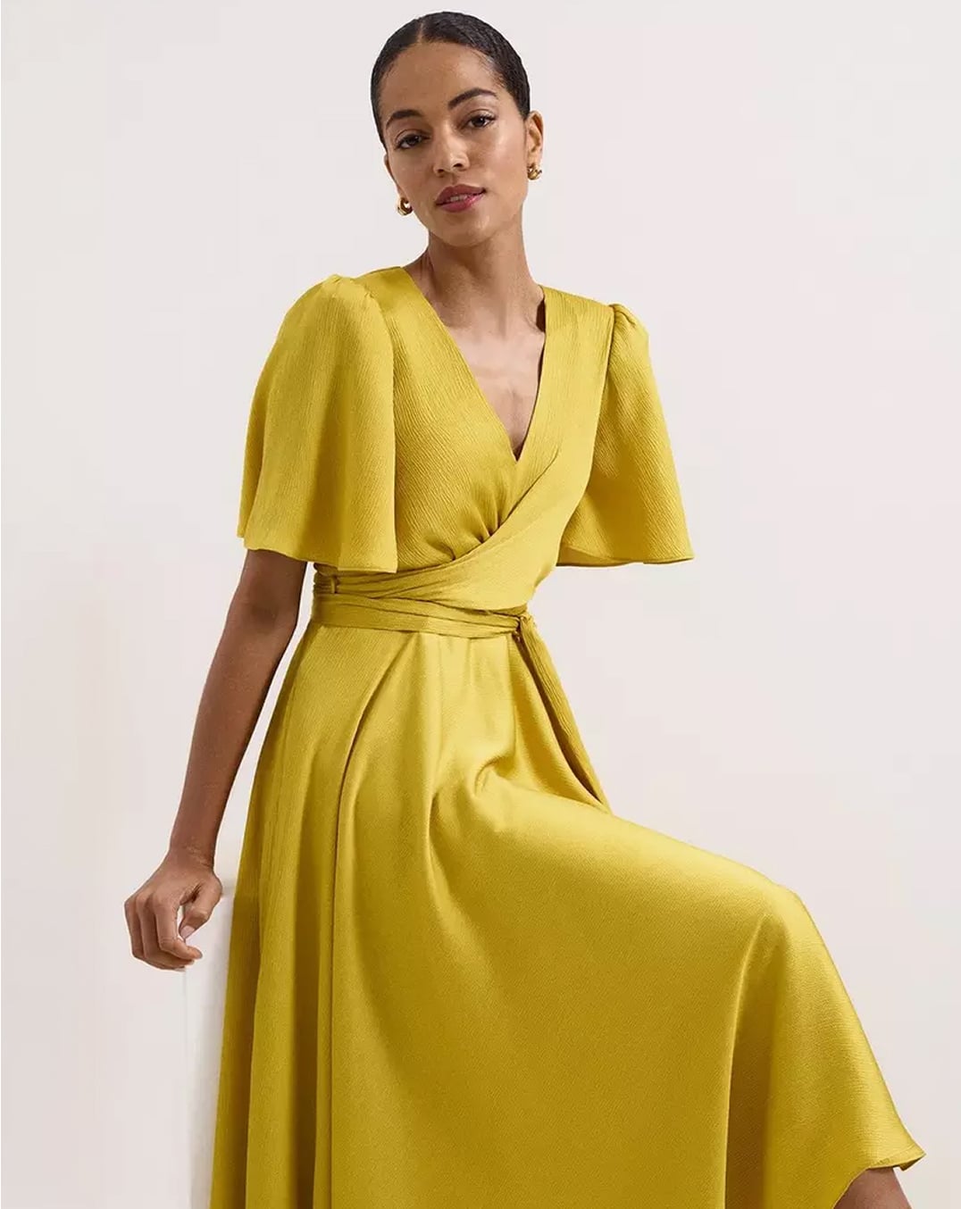 A woman wearing a Hobbs textured wrap dress.