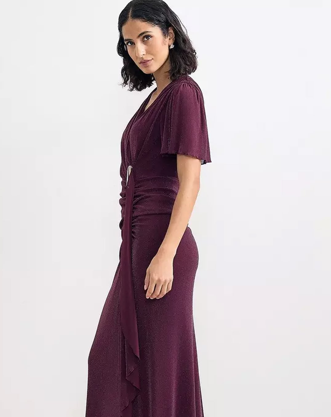 A woman wearing a Hobbs shimmer maxi dress.