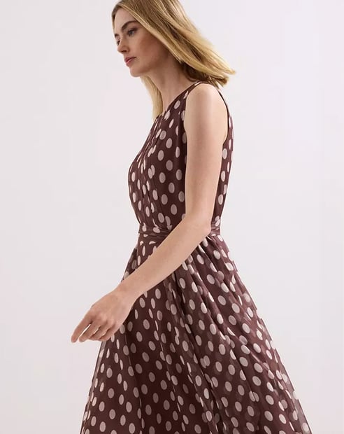 Woman in Phase Eight polka dot dress