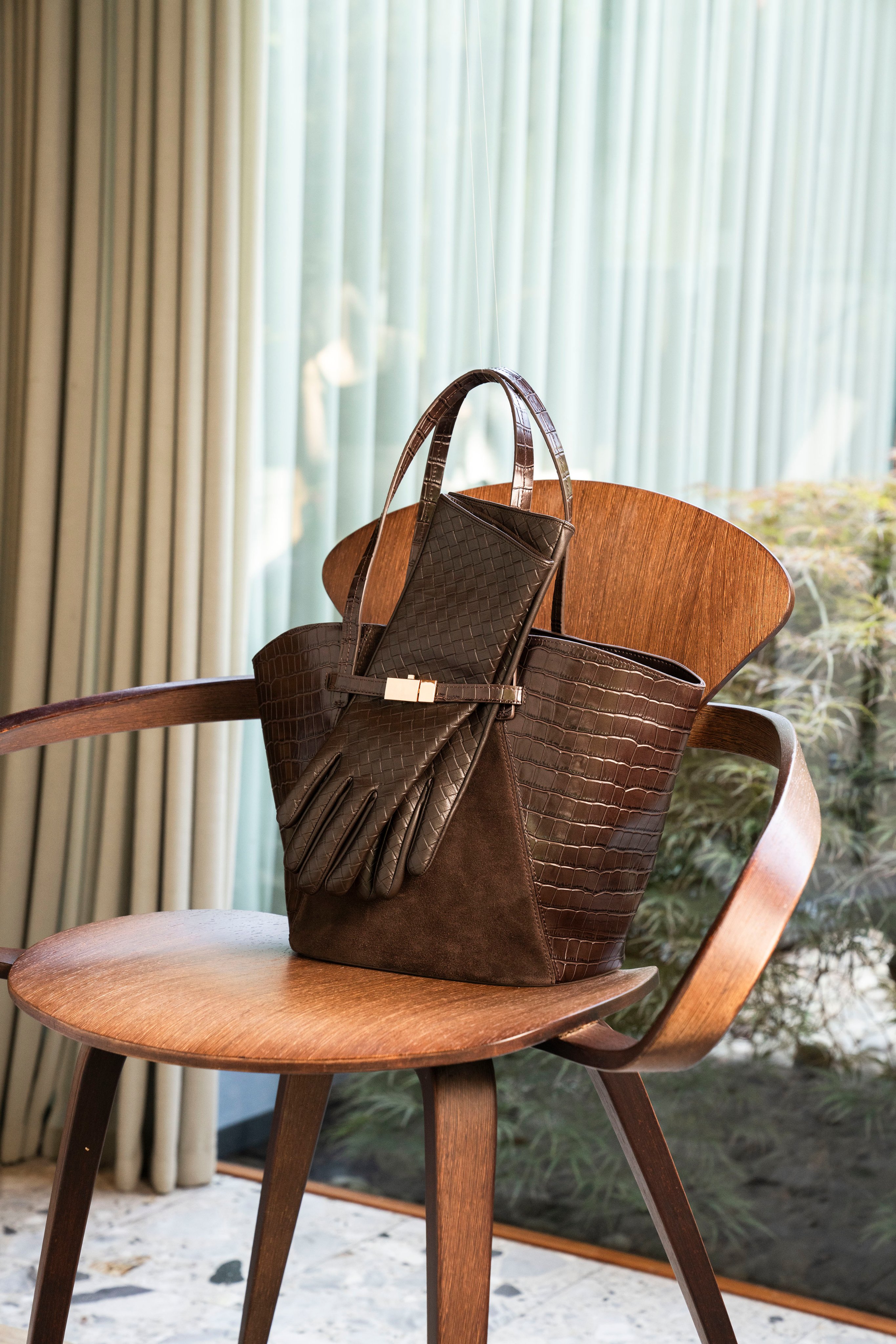 Brown croc-effect tote bag and leather gloves.