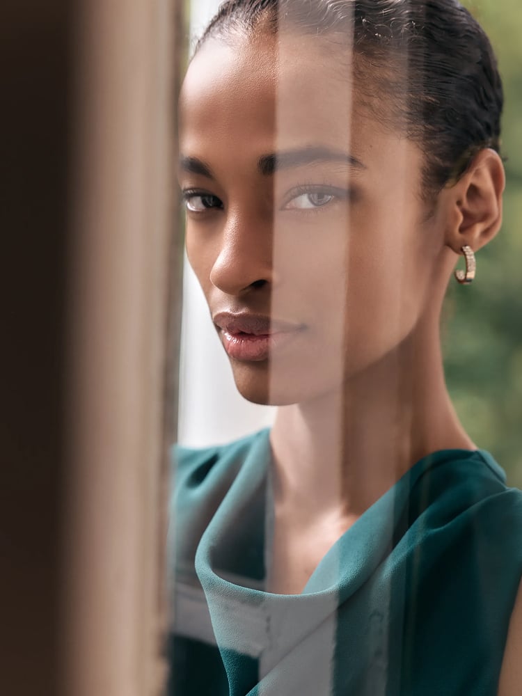 Close-up of a woman wearing a teal Phase Eight jumpsuit