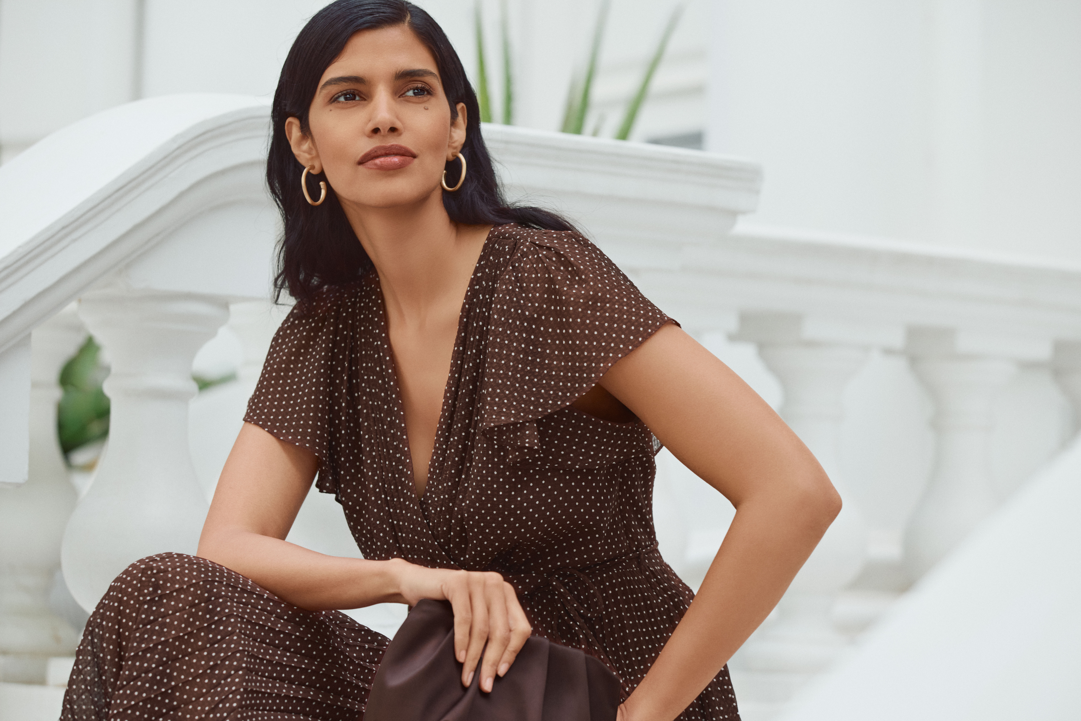 A woman wearing the Lydia camel maxi dress.