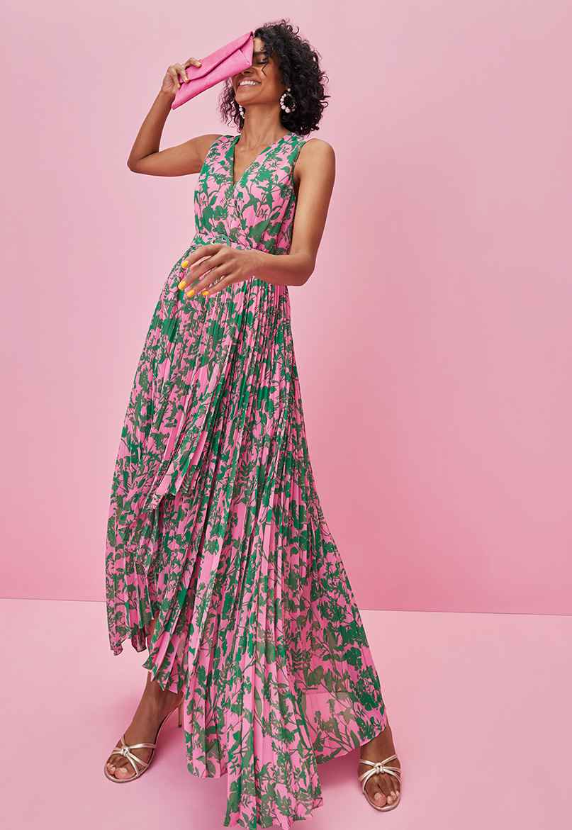 Woman in pink and green floral maxi dress