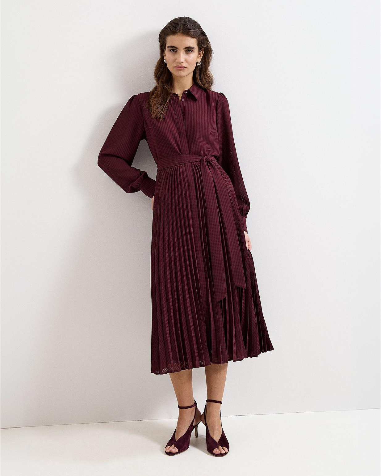 A woman wearing the Ren dress, front view.