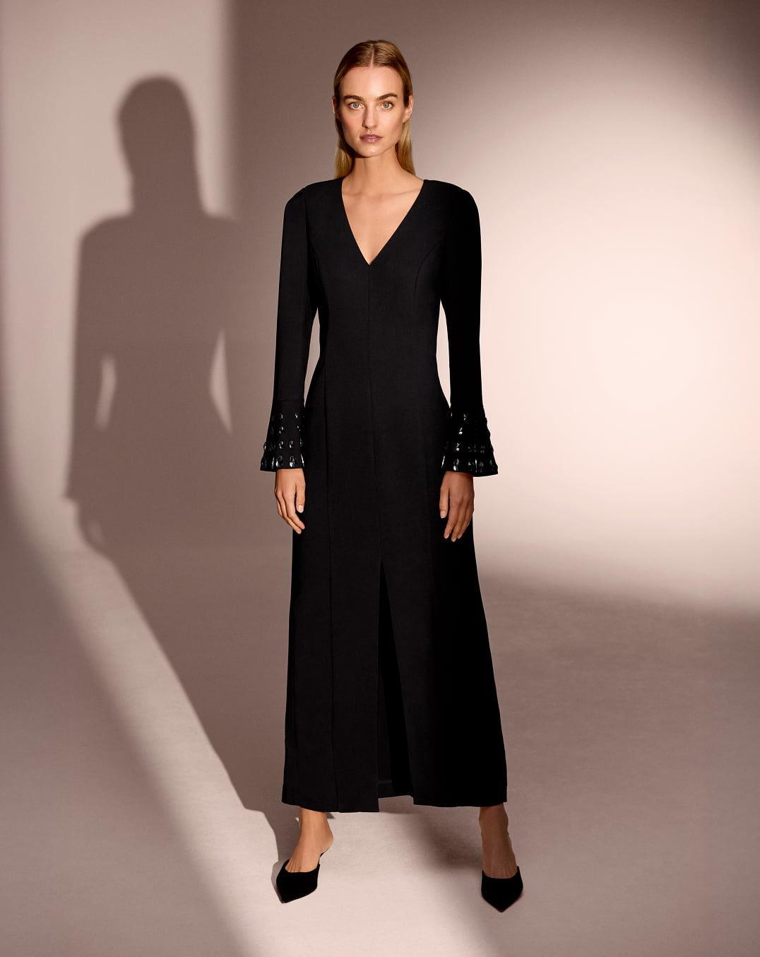 Woman wearing Phase Eight black maxi dress